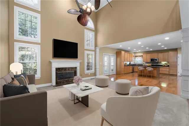 a living room with furniture a fireplace and a flat screen tv