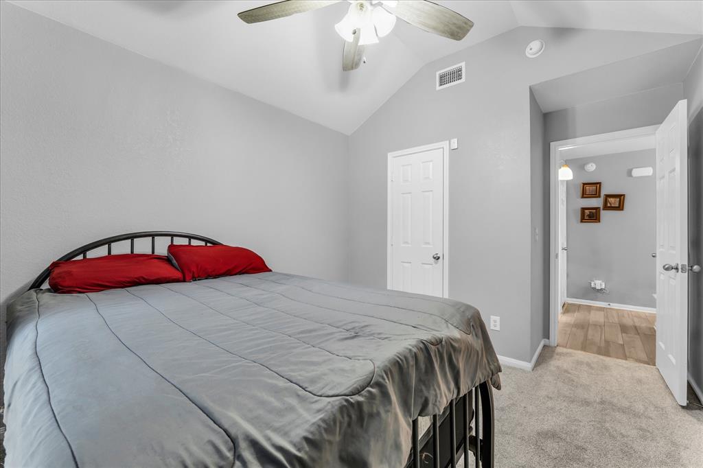 7 Market Loop Morgan's Point Resort, TX 76513 - Photo 18 of 31 Vaulted ceiling bedroom featuring a ceiling fan, carpet, and light grey walls