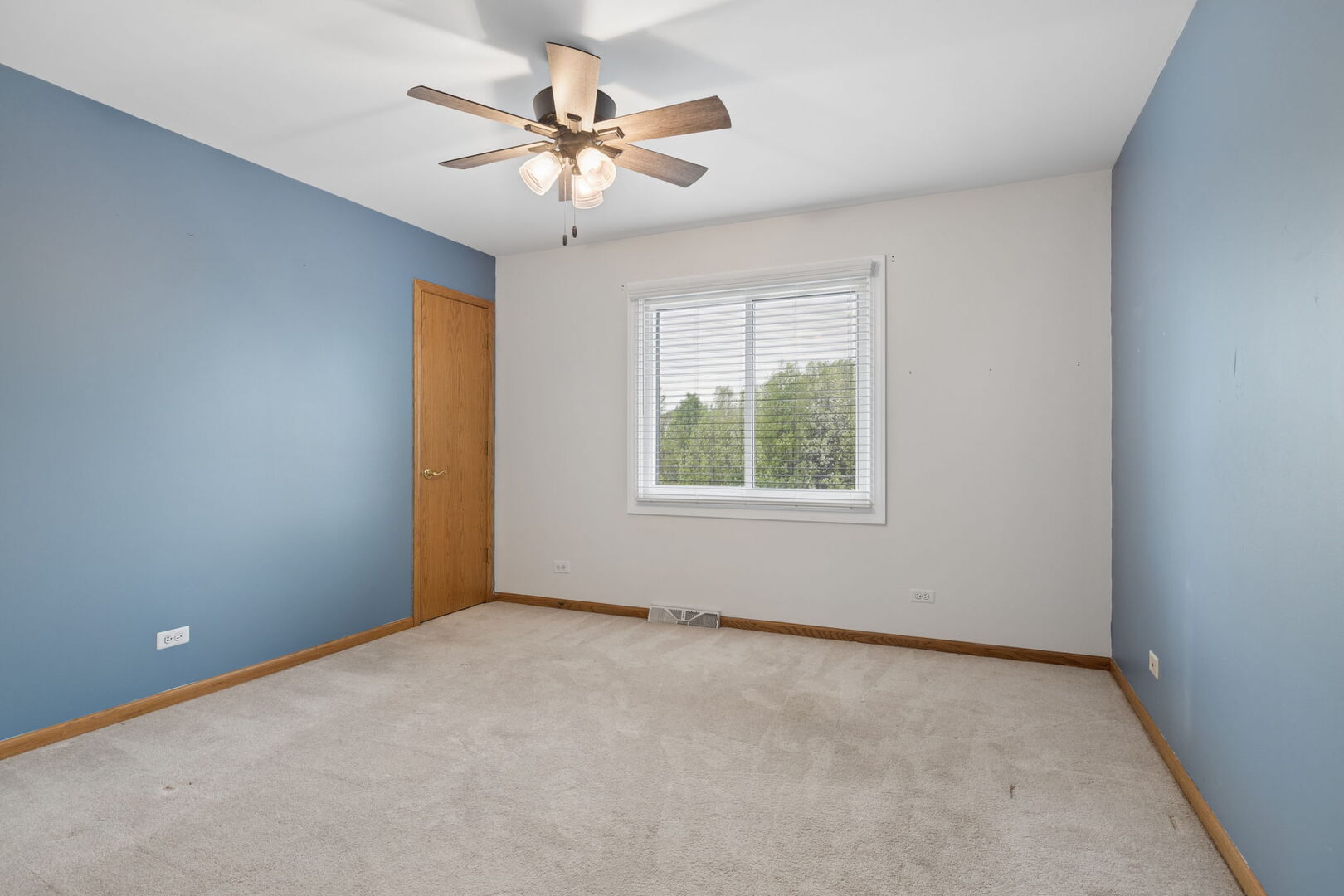 740 Countryside Drive Bolingbrook, IL 60490 - Photo 19 of 29 an empty room with a chandelier fan and windows