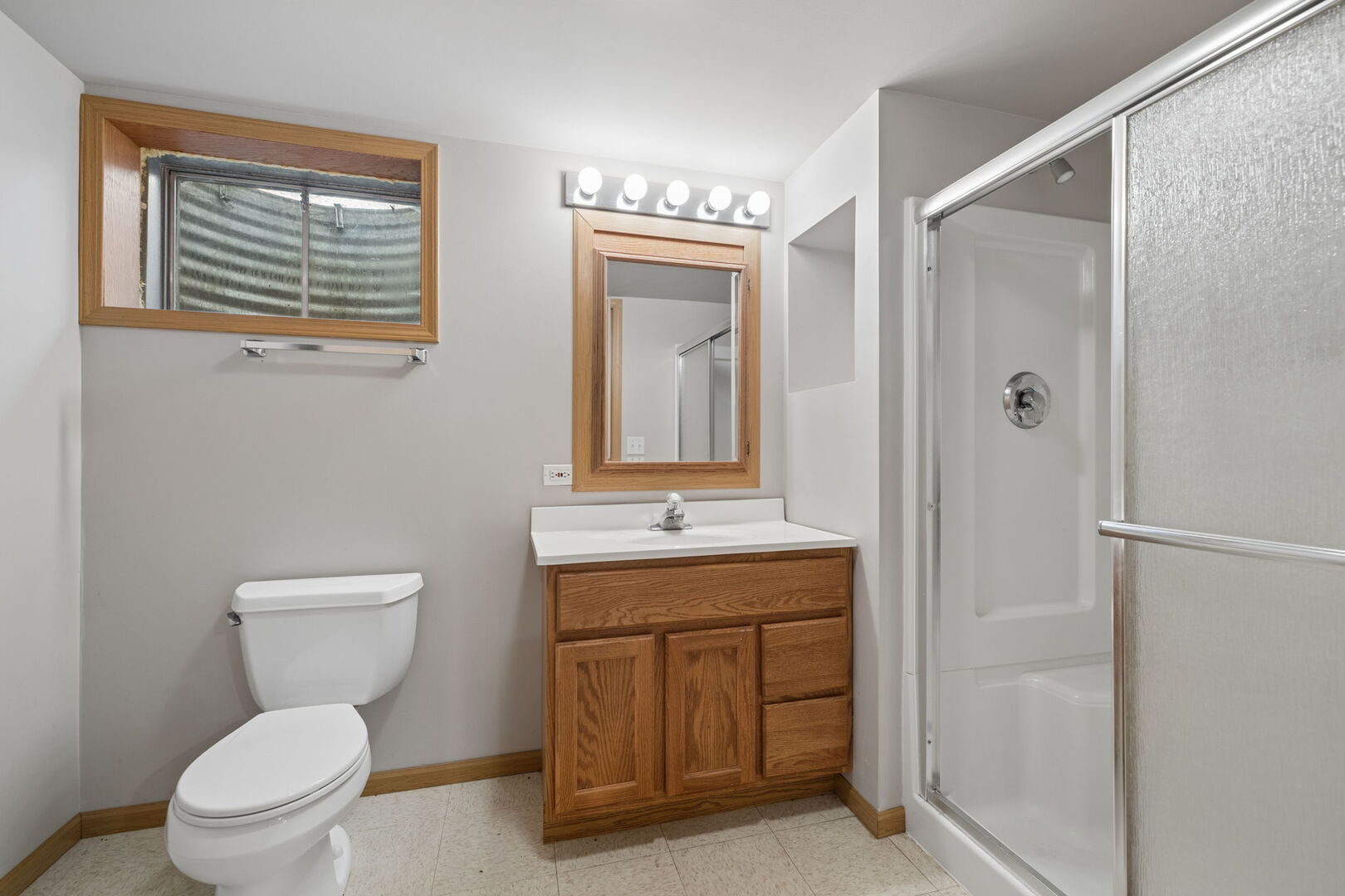 740 Countryside Drive Bolingbrook, IL 60490 - Photo 25 of 29 a bathroom with a granite countertop toilet a sink and a mirror