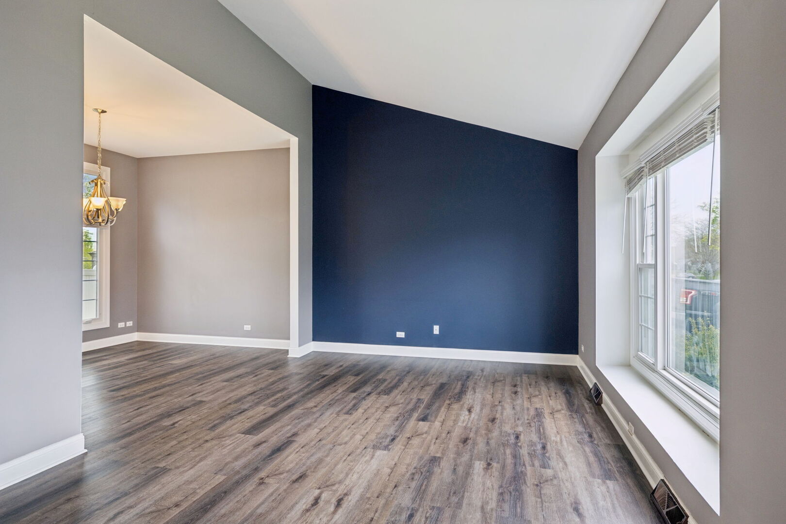 740 Countryside Drive Bolingbrook, IL 60490 - Photo 3 of 29 a view of an empty room with wooden floor and a window