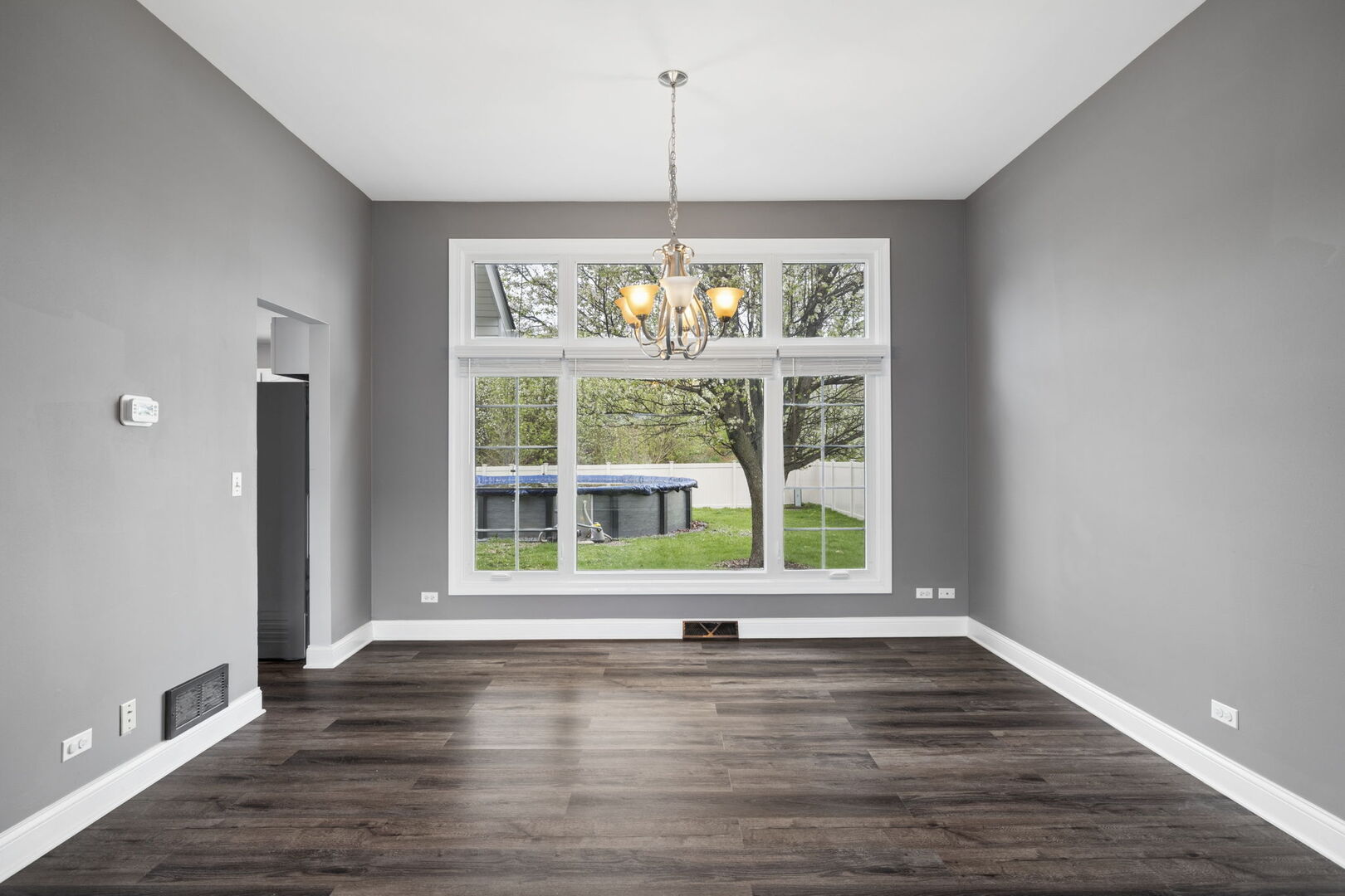 740 Countryside Drive Bolingbrook, IL 60490 - Photo 5 of 29 a view of an empty room with wooden floor and a window