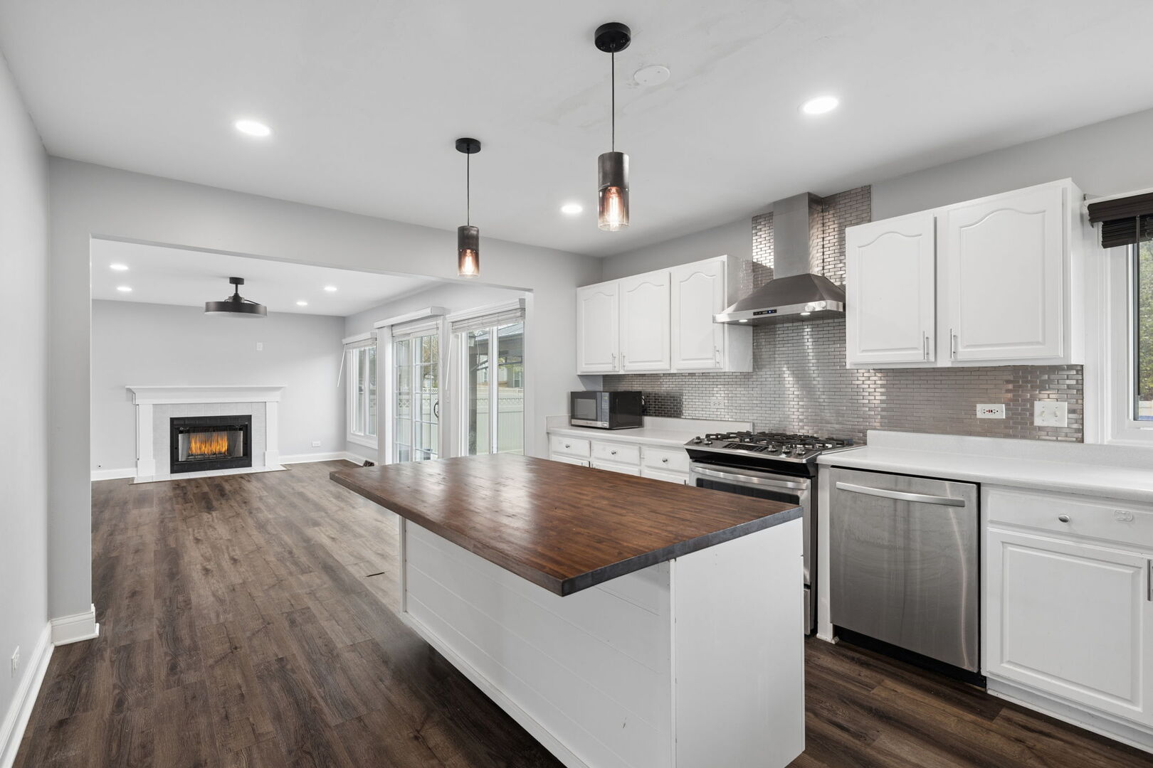 740 Countryside Drive Bolingbrook, IL 60490 - Photo 7 of 29 a kitchen with stainless steel appliances granite countertop a sink a stove and a wooden floors