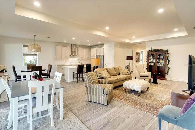 a living room with furniture and a view of kitchen