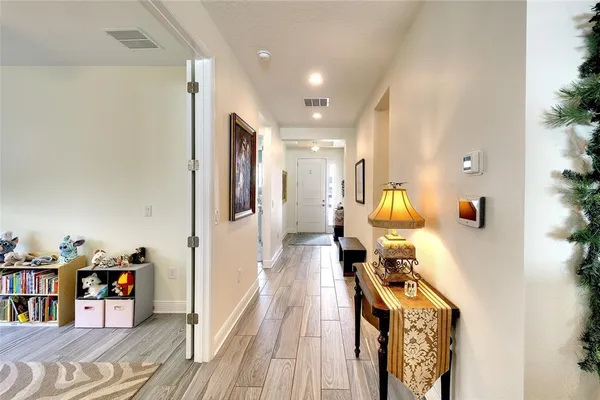 a living room with a bed furniture flat screen tv and windows