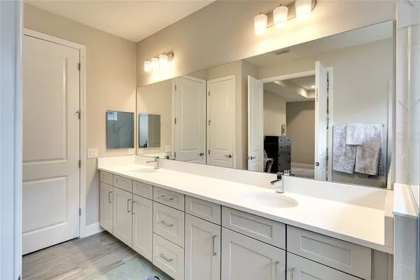 a bathroom with a sink double vanity and a mirror