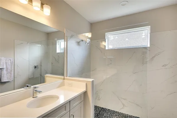 a spacious bedroom with a bed and a window