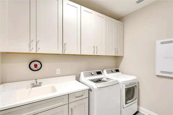 a view of a white house with a yard