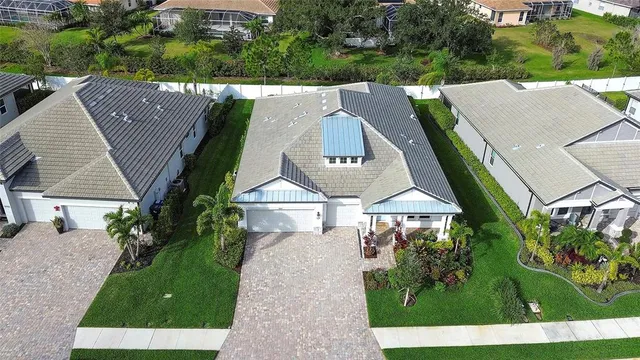 an aerial view of a house with a yard