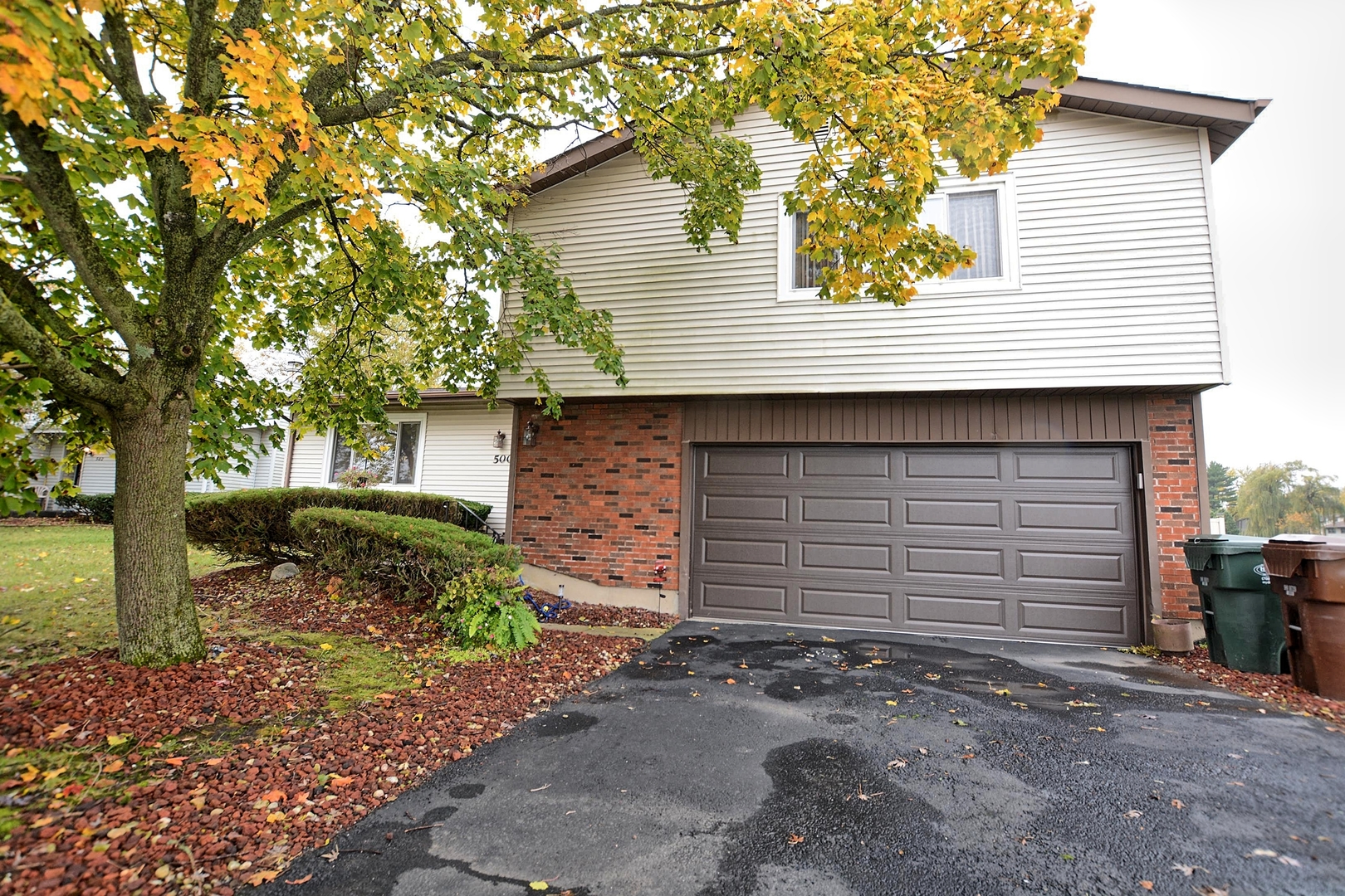 500 Farmview Road University Park, IL 60484 - Photo 1 of 27 a front view of a house with a yard and garage