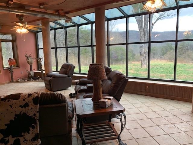 12002 Jackson River Road Monterey, VA 24465 - Photo 11 of 65 a living room with furniture and a floor to ceiling window