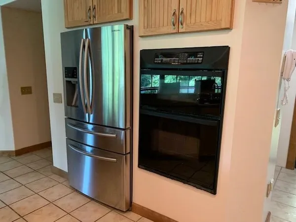 a kitchen with metallic refrigerator and stove