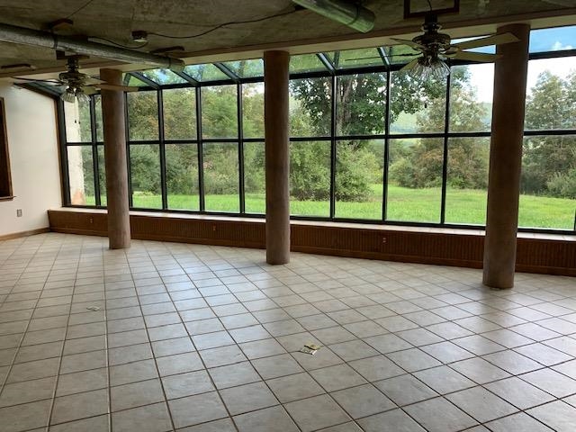 12002 Jackson River Road Monterey, VA 24465 - Photo 12 of 38 a view of empty room with wooden floor and fan