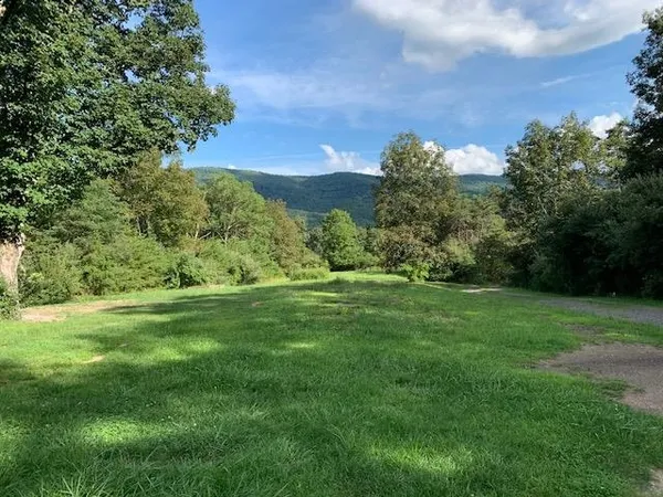a view of a field with an trees