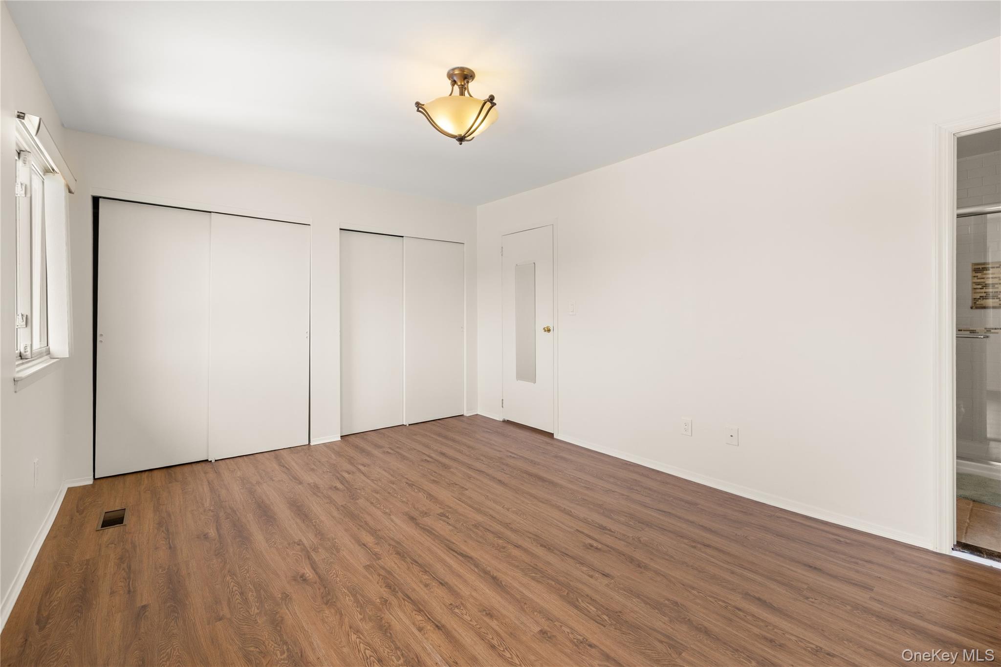 650 Newbridge Road, Unit 15 East Meadow, NY 11554 - Photo 13 of 20 a view of empty room with wooden floor