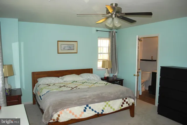 a view of a room with a chandelier fan