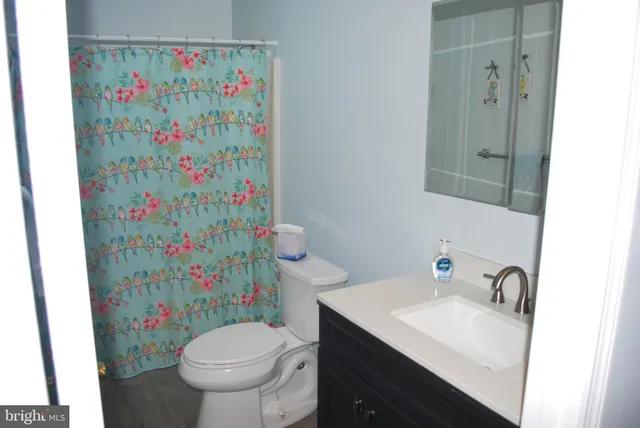 a view of a brick house with wooden fence and floor to ceiling windows