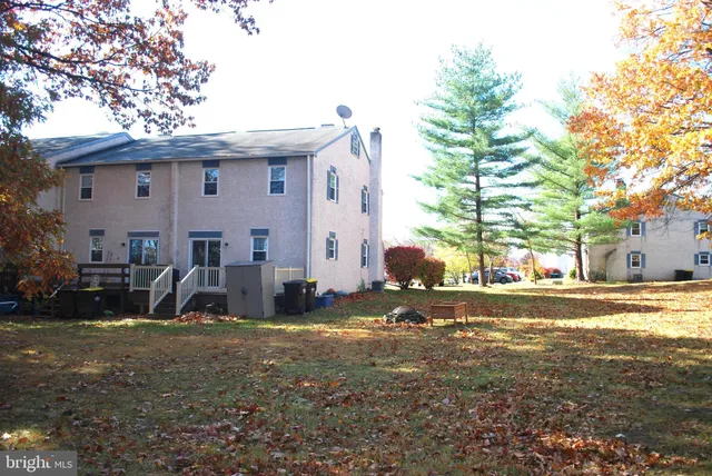 a view of a house with backyard and a tree