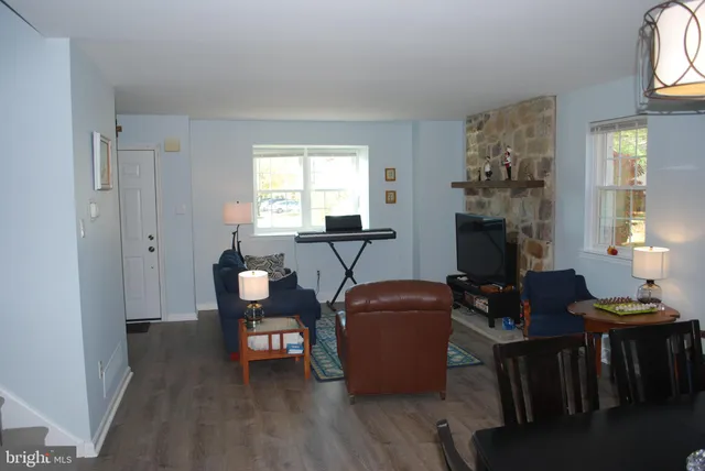 a view of a livingroom with furniture window and wooden floor