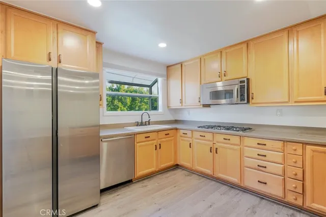 a kitchen with granite countertop cabinets and window