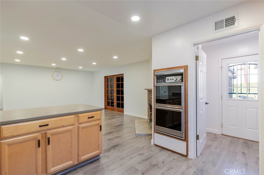 18301 Minnehaha Street Porter Ranch, CA 91326 - Photo 13 of 32 a view of a kitchen with wooden floor and electronic appliances
