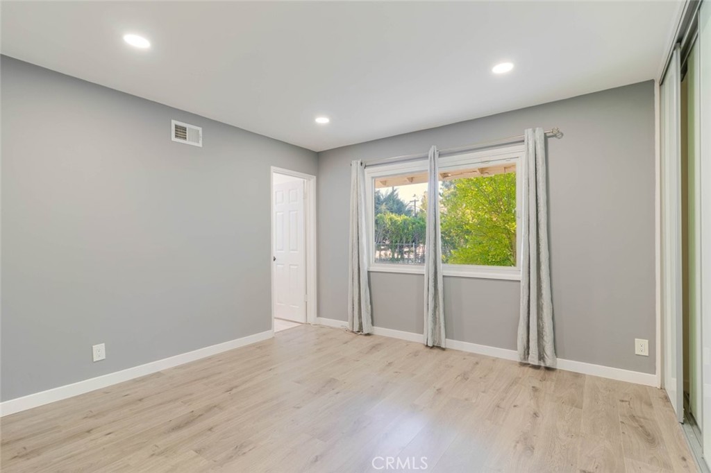 18301 Minnehaha Street Porter Ranch, CA 91326 - Photo 15 of 32 a view of an empty room with wooden floor and a window