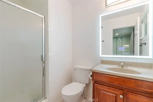 a bathroom with a sink toilet a mirror and shower