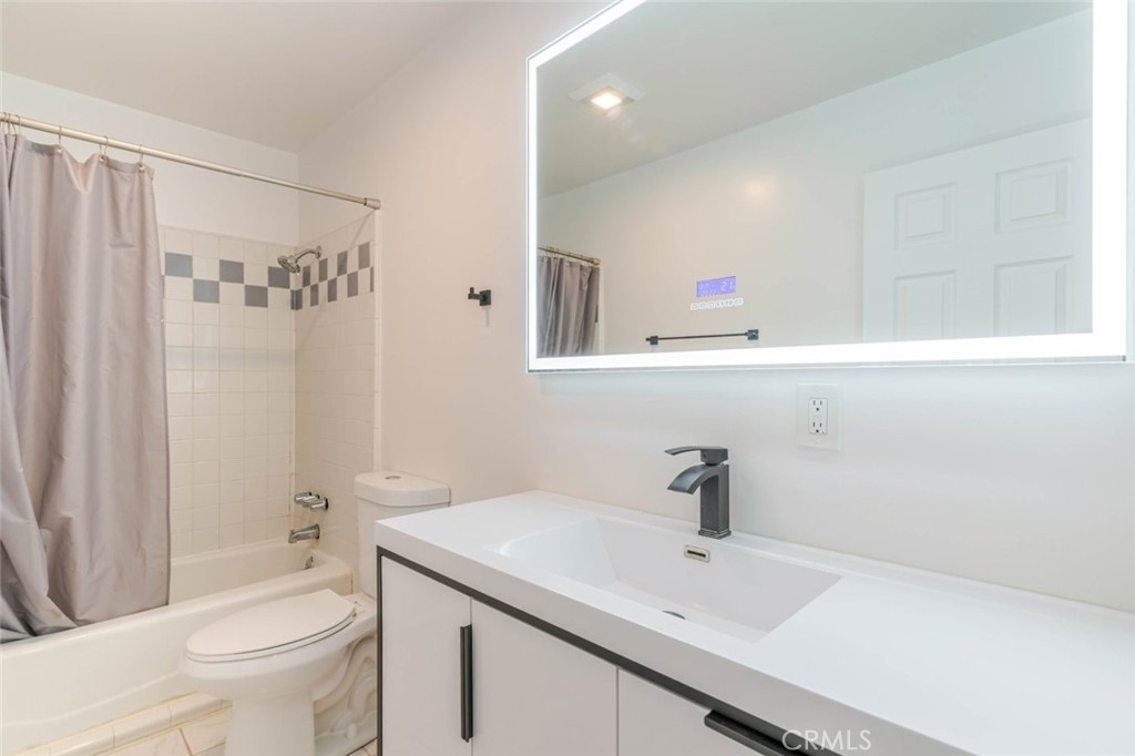 18301 Minnehaha Street Porter Ranch, CA 91326 - Photo 18 of 32 a bathroom with a sink toilet a mirror and shower
