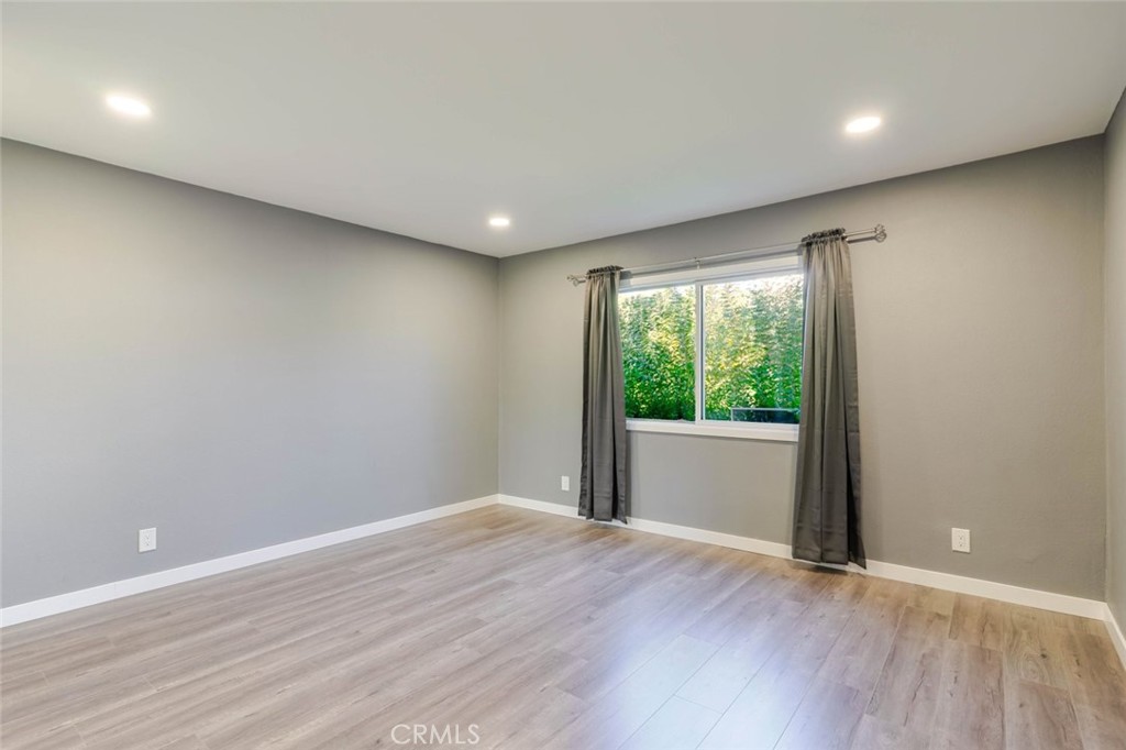 18301 Minnehaha Street Porter Ranch, CA 91326 - Photo 19 of 32 a view of an empty room with wooden floor and a window