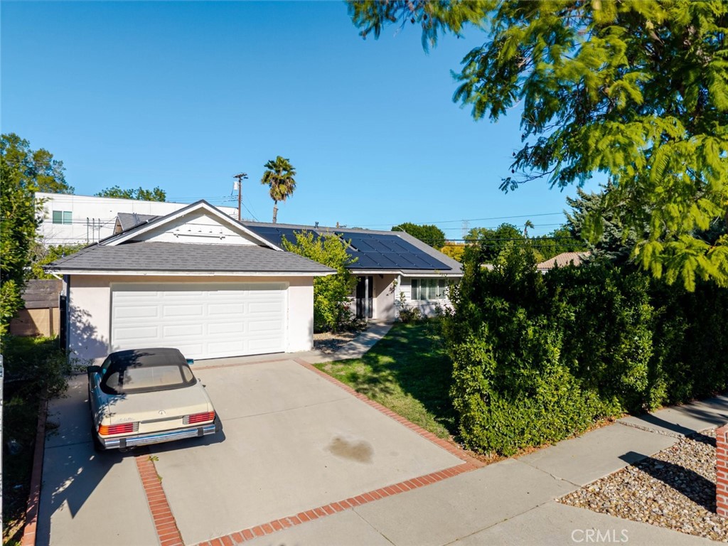 18301 Minnehaha Street Porter Ranch, CA 91326 - Photo 2 of 32 a view of a house with a small yard plants and large tree