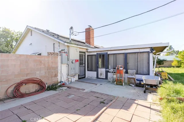 a view of a patio with table and chairs potted plants with wooden fence