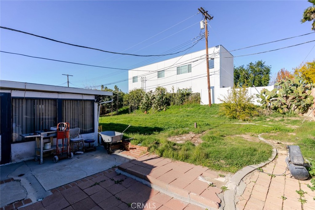18301 Minnehaha Street Porter Ranch, CA 91326 - Photo 27 of 32 a view of a patio with table and chairs potted plants with wooden fence
