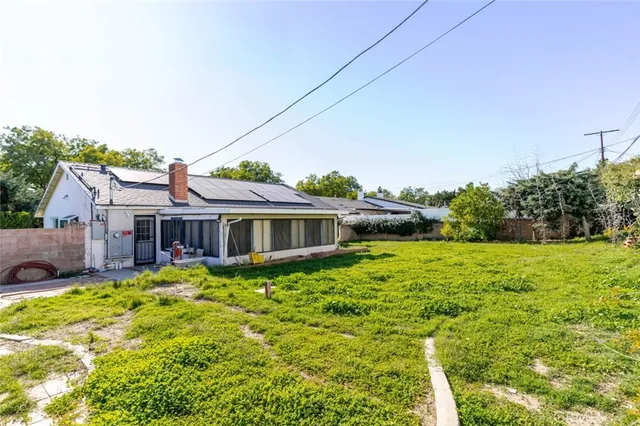 a view of a house with a yard porch and sitting area