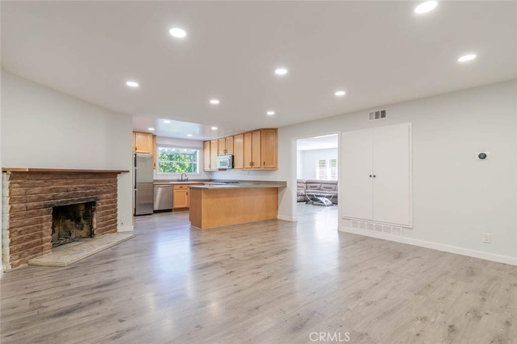 18301 Minnehaha Street Porter Ranch, CA 91326 - Photo 10 of 32 a view of a kitchen with a sink and a fireplace