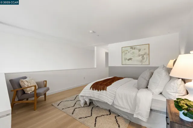 a bedroom with a bed and chair