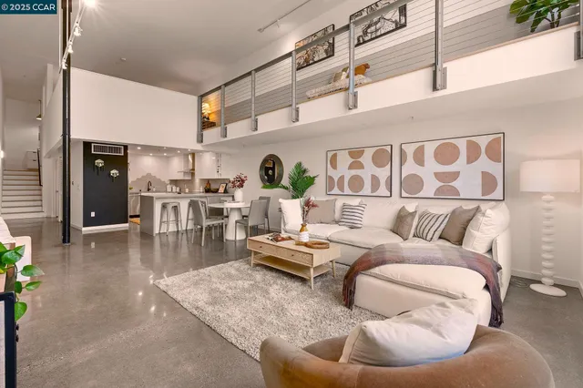 a living room with furniture and kitchen view