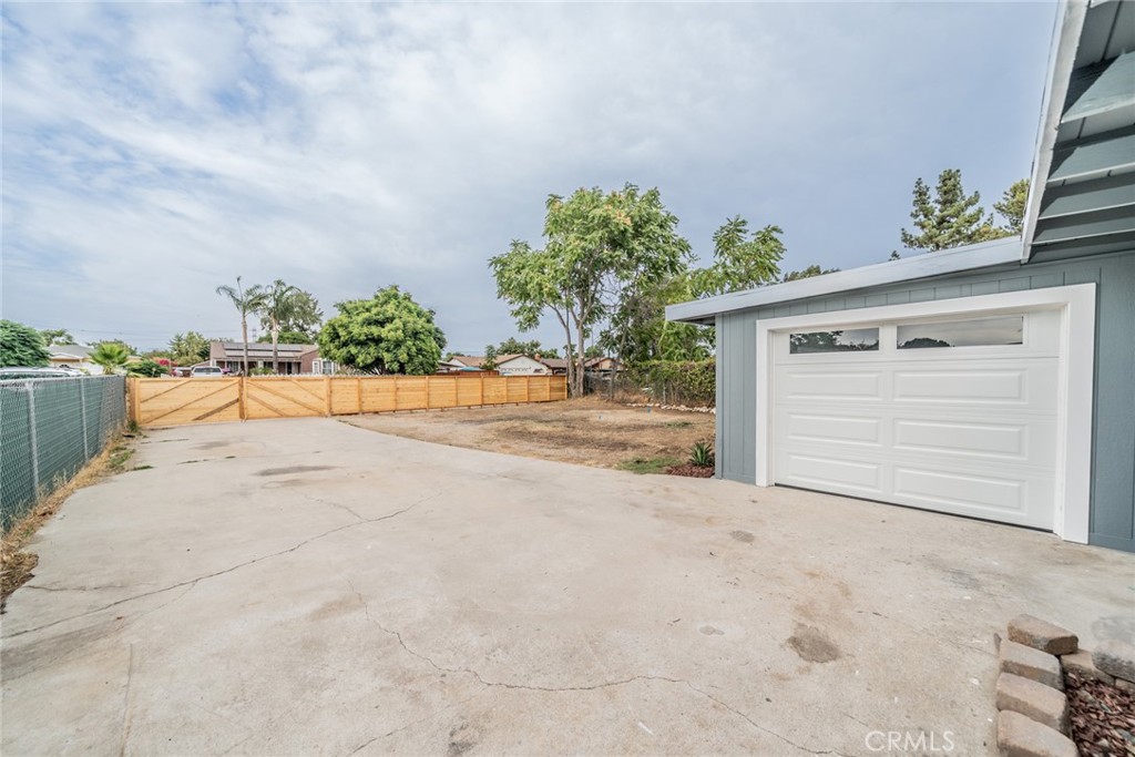 18863 8th Street Bloomington, CA 92316 - Photo 14 of 23 front view of a house with a yard and a garage
