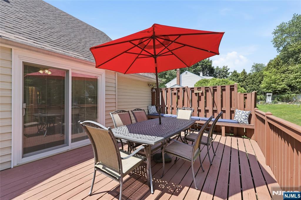 77 White Pond Road Waldwick, NJ 07463 - Photo 5 of 33 a view of deck with dinning table and chair under an umbrella