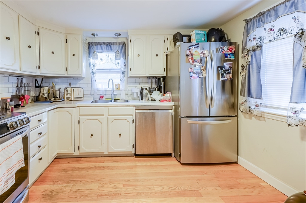 5 Oliver Street Randolph, MA 02368 - Photo 12 of 29 a kitchen with stainless steel appliances a refrigerator sink and cabinets