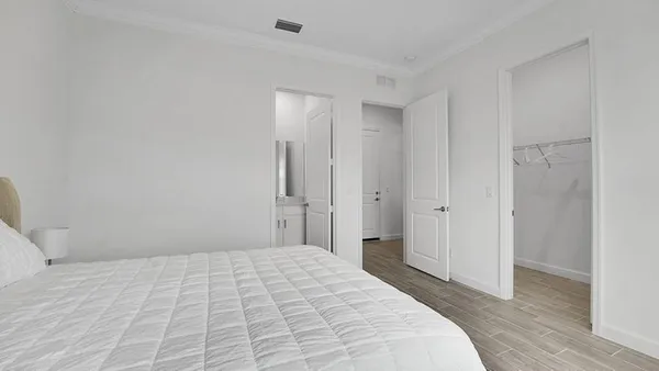 a bedroom with a bed and a mirror