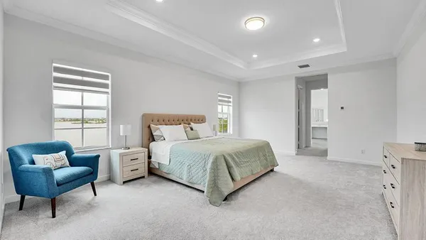a spacious bedroom with a bed and a window