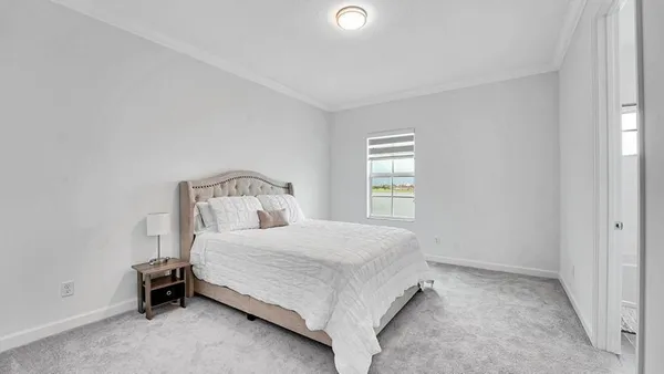 a bedroom with a bed and window