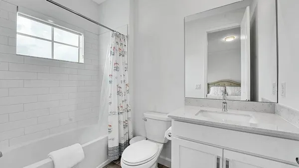 a bathroom with a sink toilet a mirror and shower