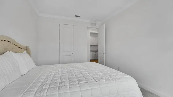 a bedroom with a bed and a night stand