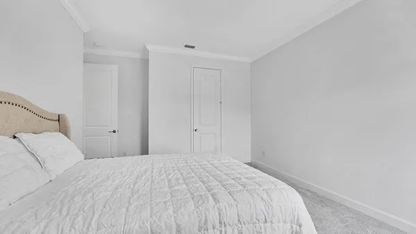 a bedroom with a bed and a night lamp