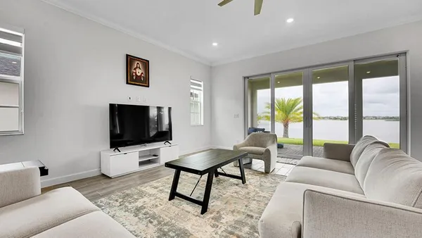 a living room with furniture and a flat screen tv