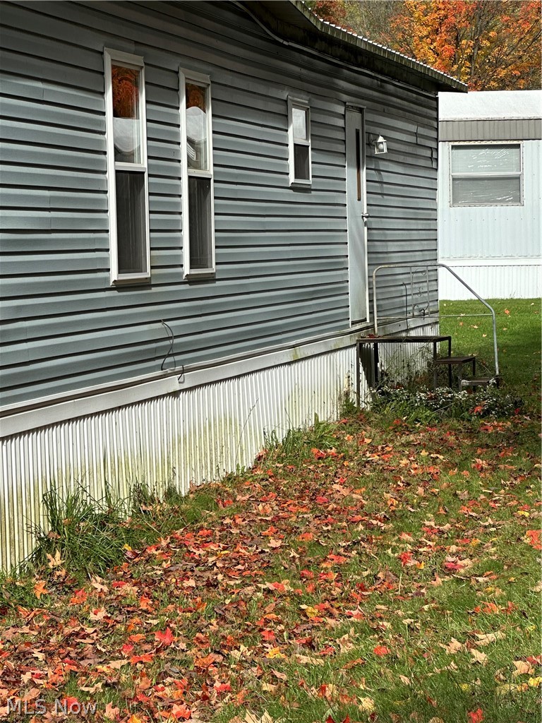 7443 Spillway Road Lisbon, OH 44432 - Photo 3 of 19 View of property exterior with a yard