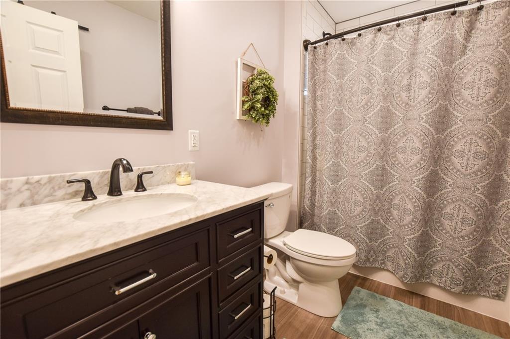107 Cole Road Sarver, PA 16055 - Photo 13 of 21 a bathroom with a granite countertop sink a toilet and a mirror