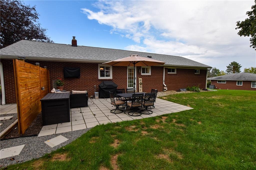 107 Cole Road Sarver, PA 16055 - Photo 20 of 21 a view of a backyard with table and chairs under an umbrella