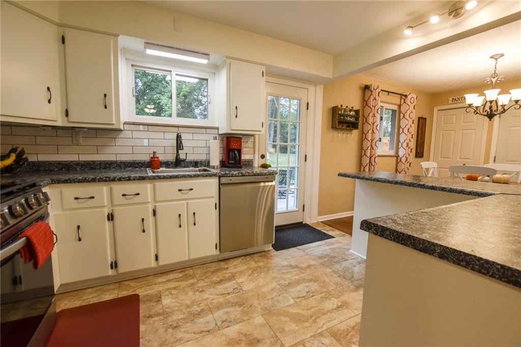 107 Cole Road Sarver, PA 16055 - Photo 8 of 21 a kitchen with granite countertop a sink a stove and cabinets